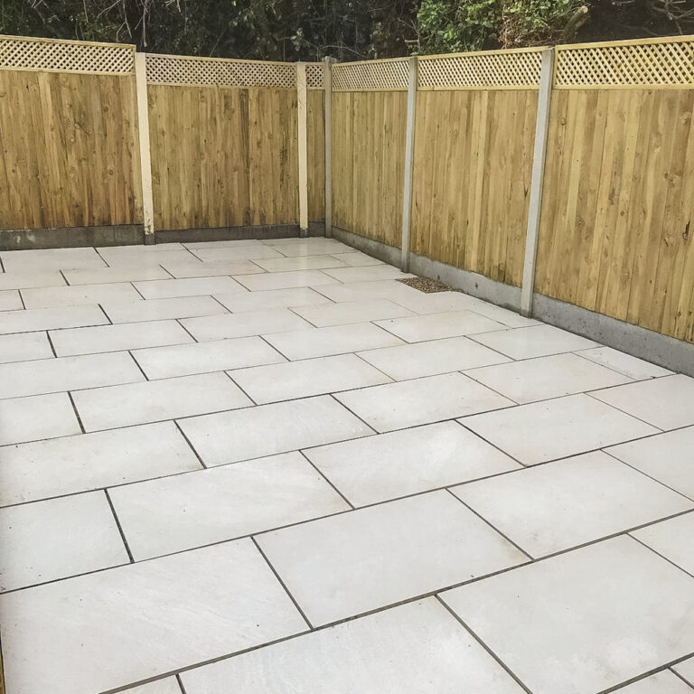 Patio with closed board panel fencing with trellis top